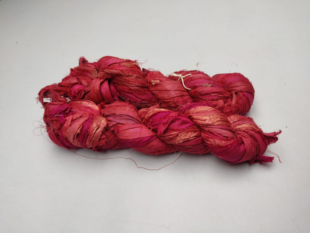 Recycled Sari Silk Ribbon-Brick is the by-product of colorful saris that women wear in India. It is the loose ends of saris collected from industrial mills in India that is torn in stripes and sewn end to end to make beautiful and colorful ribbons. The vibrant colors and unique texture of these silk fabric, the sari silk ribbons are inspirational to designers, knitters, and artisans.
