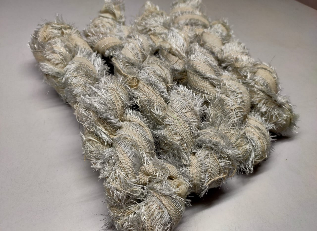 Recycled Metallic Frizz Ribbon is perfect for incorporating into weavings and adding contrasting texture. Metallic Frizz Ribbon can be used for creating home goods, rugs, wall art, and more. This recycled cotton ribbon is fair trade, ethically sourced from India, and hand dyed in small batches.