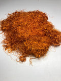 Banana viscose fiber in Orange, skein on white background - silk-routeindia