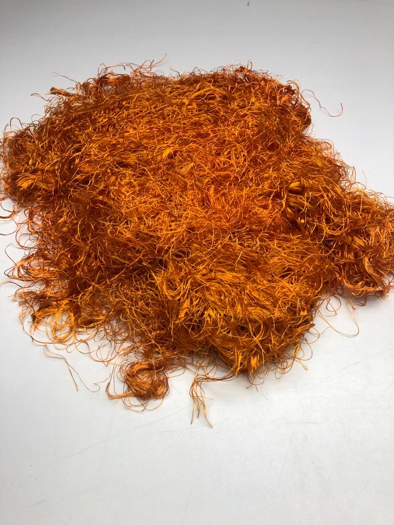 Banana viscose fiber in Orange, skein on white background - silk-routeindia