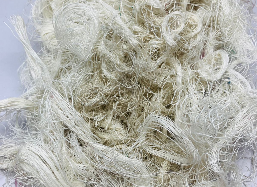 Recycled Linen Yarn Waste are the leftover or excessive warp/ weft thread on handlooms/ powerloom, to be specific the byproduct linen from industrial Linen weaving unit in India. There’s no dye lot on recycled Linen Fiber. These recycled fiber waste are the remnants of traditionally crafted Indian Linen yarn and are extensively used in making hats, mittens & hand scarves. Each lot has distinct colors, as its a mixed lot of white, natural white, off White or undy