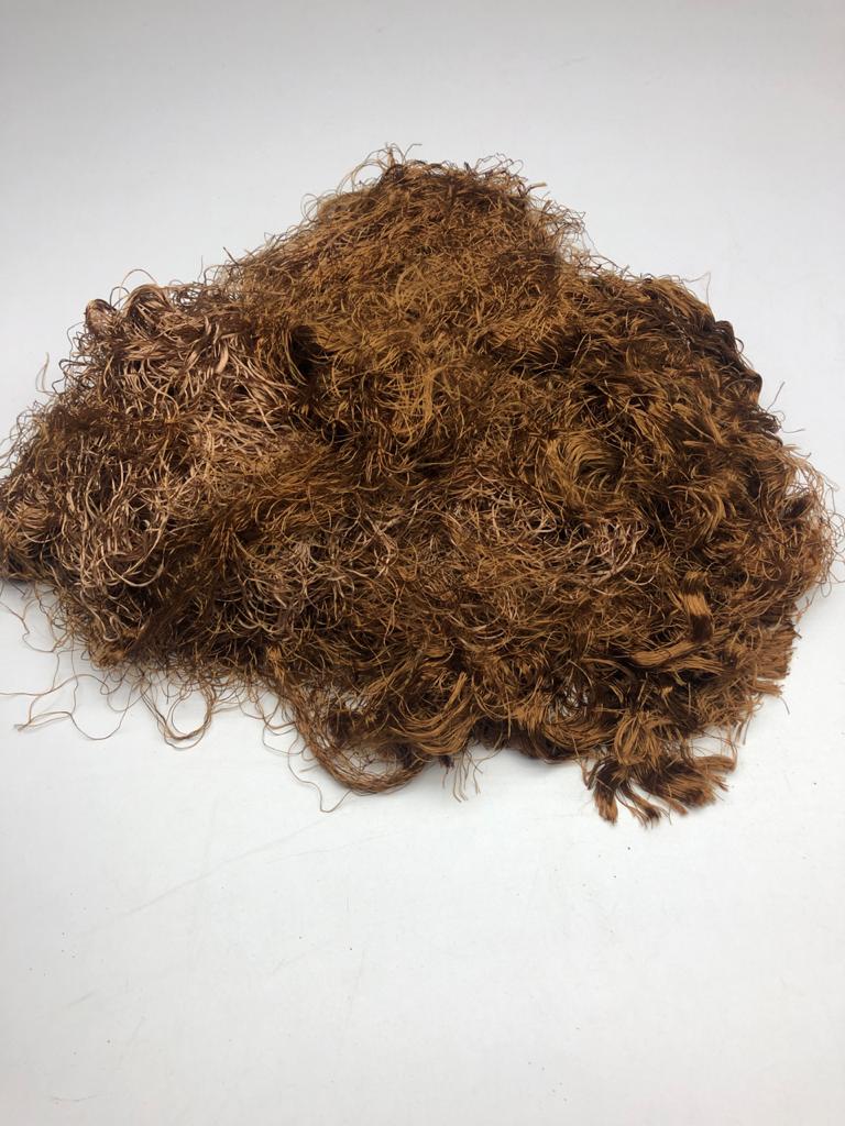 Banana viscose fiber in Golden Brown, skein on white background - silk-routeindia