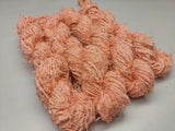 Recycled Linen Yarn - Peach is made from leftover or excessive warp/ weft thread on handlooms/ powerloom, to be specific the byproduct linen from industrial Linen weaving unit in India. This recycle yarn is hand-spun, using drop spindle helping women cooperatives to earn their livelihood