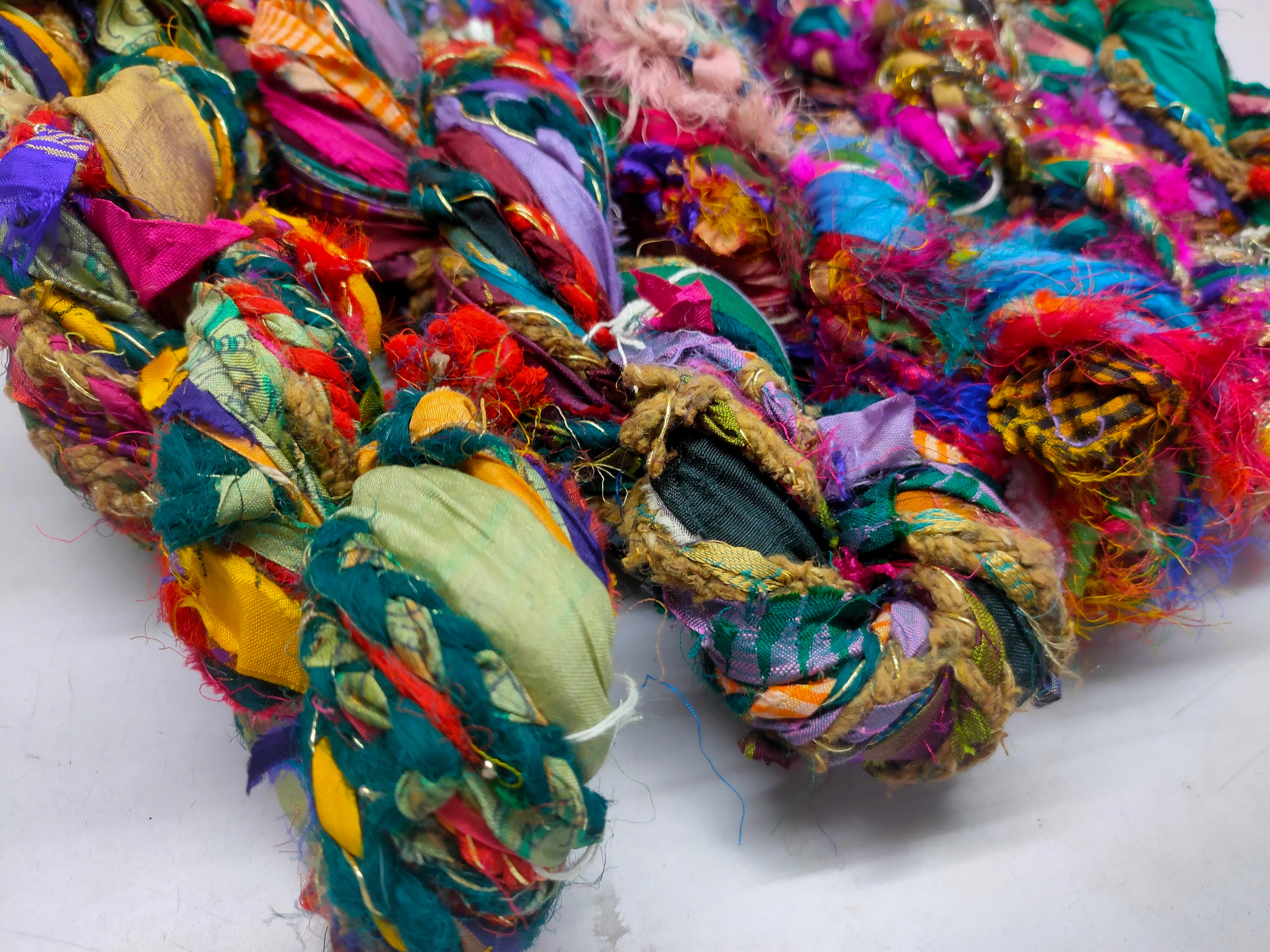 Recycled Yarn - Braided Lurex - SilkRouteIndia - Recycled Yarn - Braided lurex is available in multitude of colors. We fabricate Recycled Sari Yarn from the bi-product of sari and silk production units. The Yarn, available with us, is hand spun into bright hanks which is suitable for number of Handicrafts applications.